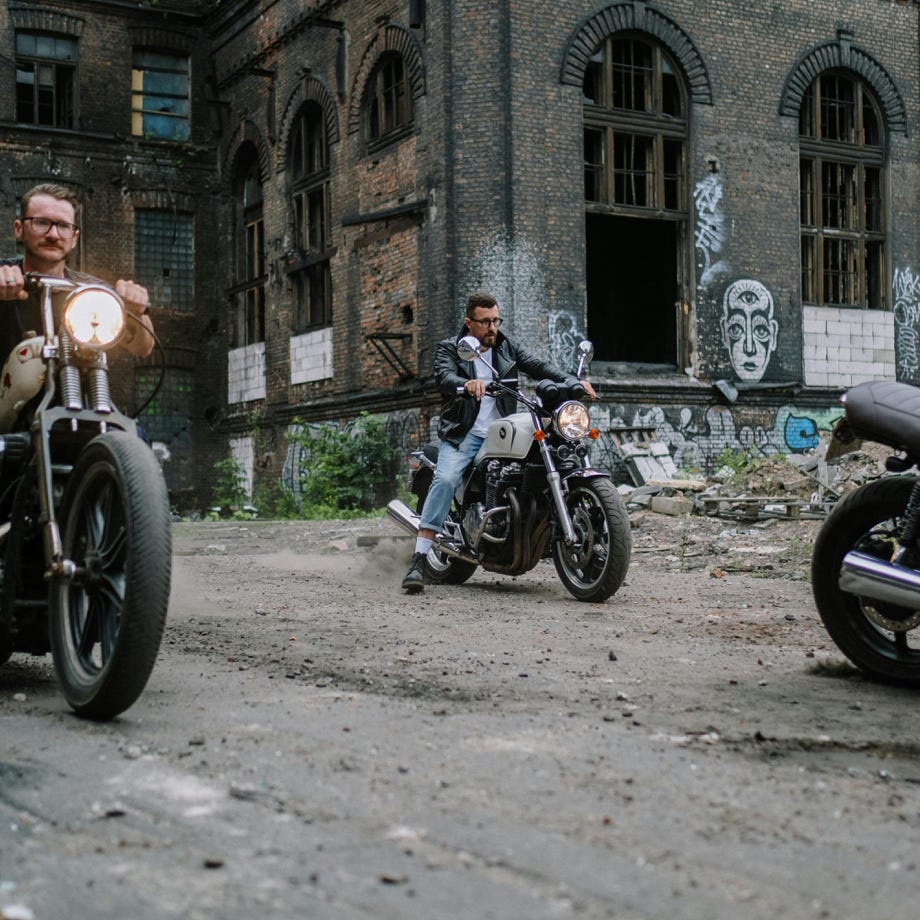 Group of bikers riding motorcycles through an abandoned urban area, showcasing a sense of freedom and adventure.